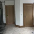Two oak internal doors with matching frames in a new-build hallway